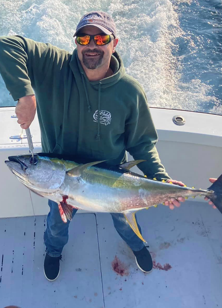 Happy OBX angler holding nice yellowfin tuna. Happy OBX angler holding nice yellowfin tuna.